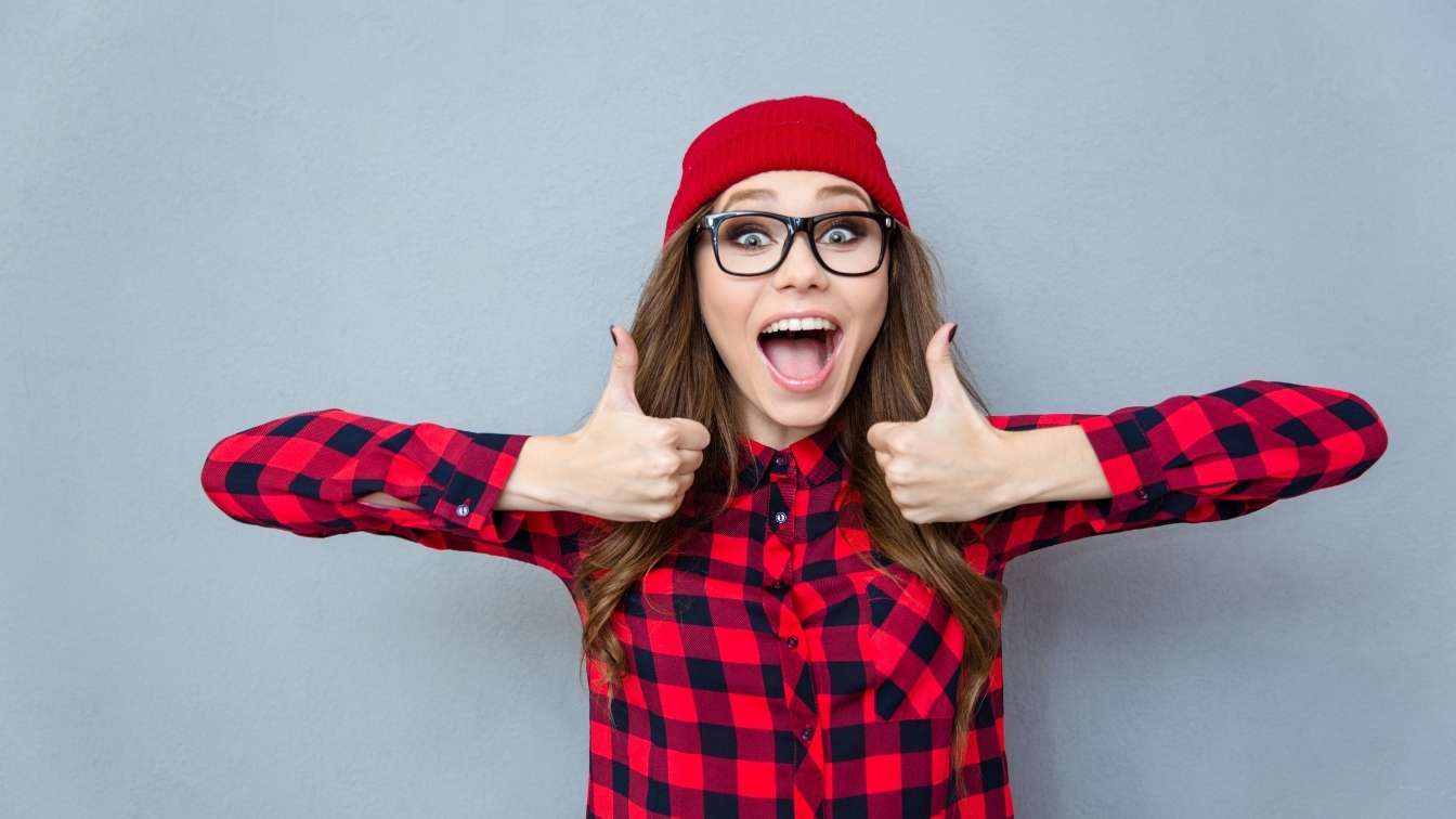 Smiling girl with two thumbs up